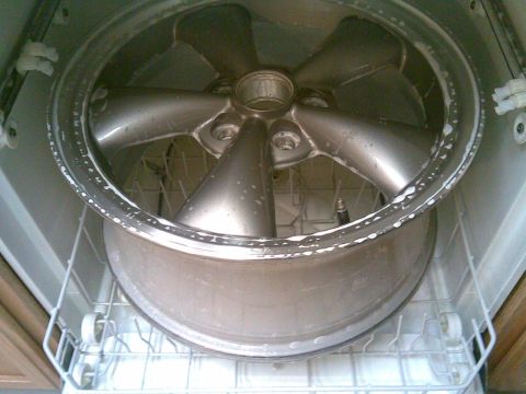 2003 Ford Crown Victoria - A car wheel is placed inside a dishwasher for cleaning.