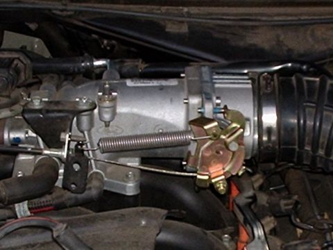 2003 Ford Crown Victoria - Throttle body and associated engine components are shown in this close-up view.