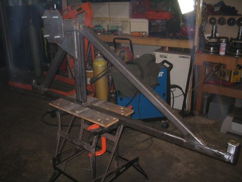 1989 Ford Bronco - A custom metal frame assembly is shown in a workshop setting, likely a part for a vehicle.