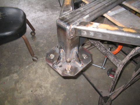 1989 Ford Bronco - Close-up view of a welded metal frame corner a hexagonal mounting plate secured with bolts.