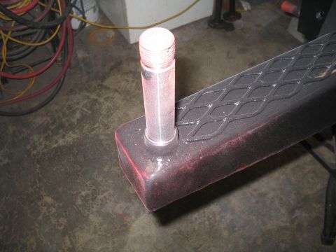 1989 Ford Bronco - A trailer hitch receiver with a threaded pin is shown in a workshop setting.