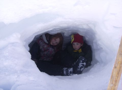 1986 Ford Bronco - Two children find shelter and enjoy a winter day inside a snow fort.