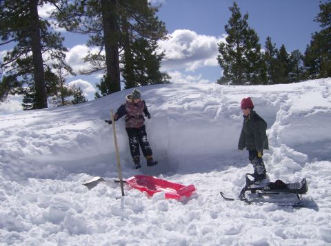 1986 Ford Bronco - Children enjoy a winter day playing in the snow with sleds and a shovel.