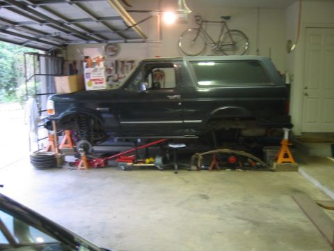 1995 Ford Bronco - This 1995 Ford Bronco is up on jack stands in a garage, undergoing maintenance.