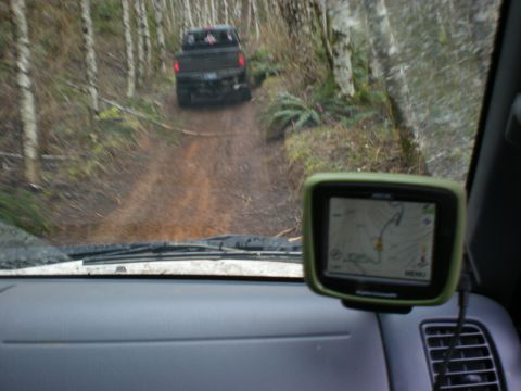 1993 Ford Bronco - A black pickup truck navigates a muddy forest trail, viewed from the perspective of a following vehicle equipped with a GPS unit.