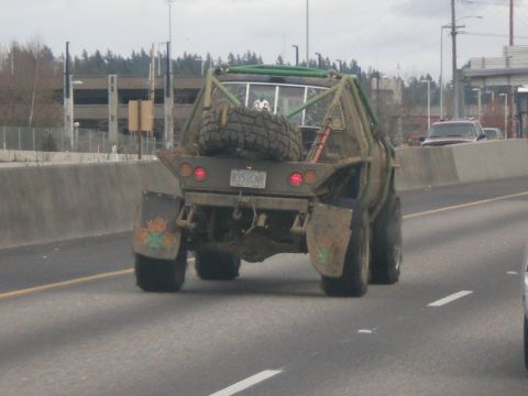 1993 Ford Bronco - This heavily modified truck features a custom roll cage and a spare tire mounted on the rear.