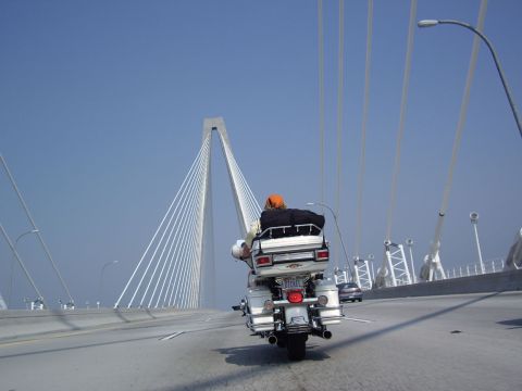 2005 BMW R1200CA ABS - A motorcycle rider travels across a large suspension bridge on a clear day.