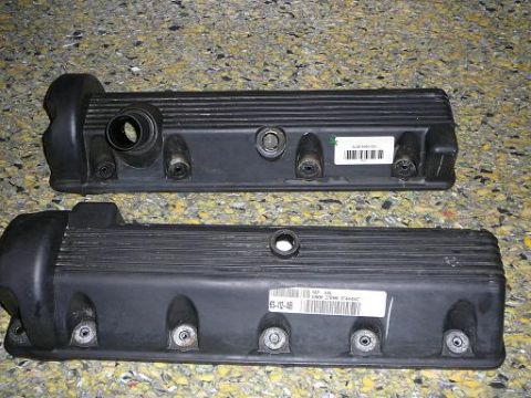1997 Mercury Grand Marquis - Two black valve covers are shown, each with visible labels and part numbers.