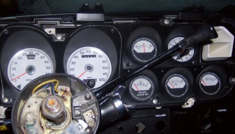 1976 Ford Ranchero - Close-up of a vehicle's dashboard gauges, showing a speedometer, tachometer, fuel, oil pressure, and temperature gauges.