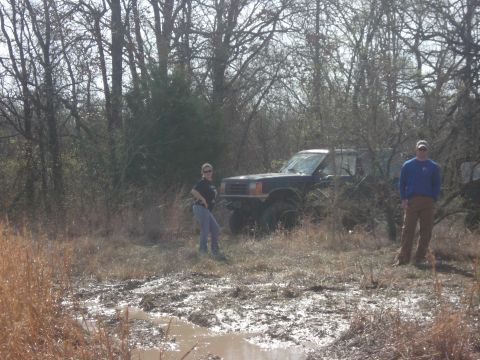 1989 Ford Bronco II - A 1989 Ford Bronco II is seen off-road with two people observing.
