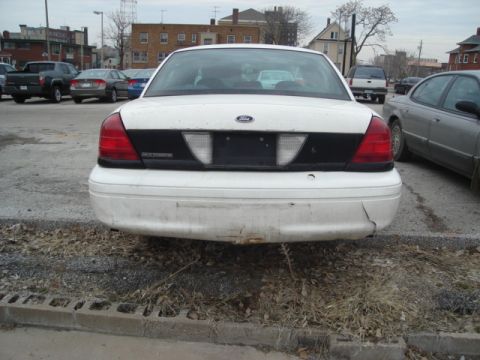 2000 Ford Crown Victoria - Rear view of a white 2000 Ford Crown Victoria parked outdoors.