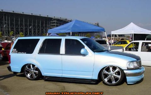 2000 Ford Expedition - A light blue 2000 Ford Expedition is parked outdoors with custom wheels and a lowered stance.
