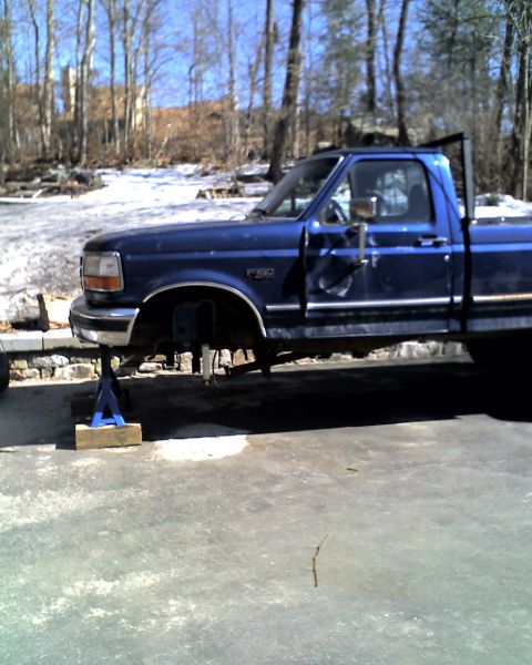 1996 Ford F-150 - Blue 1996 Ford F-150 pickup truck is raised on jack stands for maintenance.