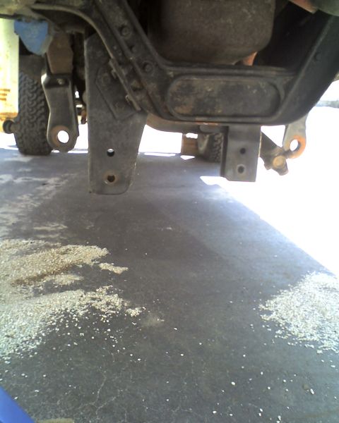 1996 Ford F-150 - A close-up view of a truck's undercarriage, showing suspension parts and a filter.