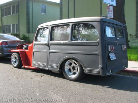 1968 Ford Mustang - This customized Willys Station Wagon features a dark gray body, red front fenders, and aftermarket wheels, sitting low on the street.
