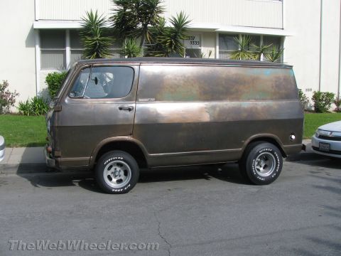 1968 Ford Mustang - This panel van has a unique, aged finish and is parked curbside in front of a building.