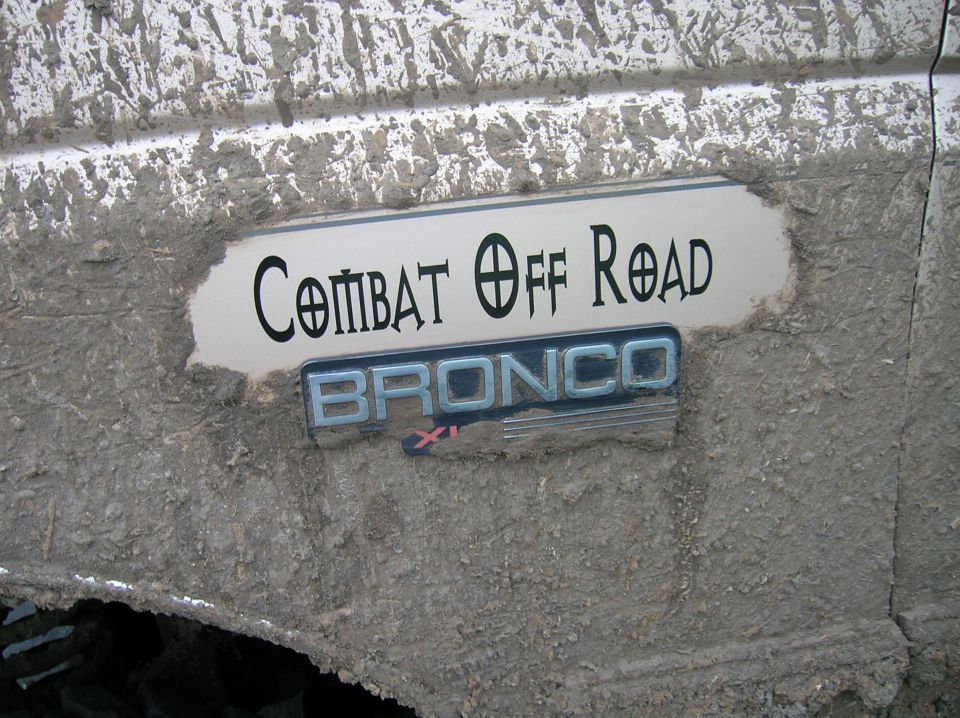 Muddy white panel with chrome BRONCO XL emblem and Combat Off Road decal