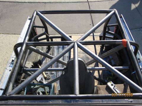 1994 Ford Bronco - A custom roll cage is installed in the bed of a truck, obscuring the vehicle's original features.