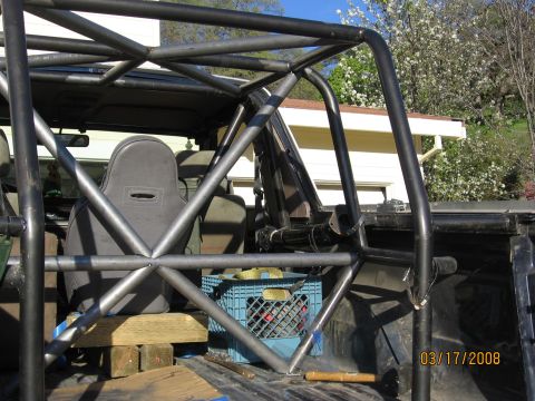 1994 Ford Bronco - The photo shows a custom roll cage installed in the bed of a pickup truck.