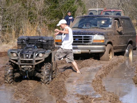 1981 Jeep CJ7 - Muddy Ford Bronco and ATV navigating a difficult off-road trail.
