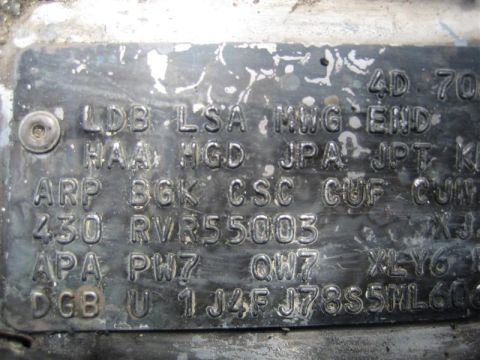 1987 Suzuki Samurai - This VIN plate shows embossed characters and numbers, likely from a vehicle.