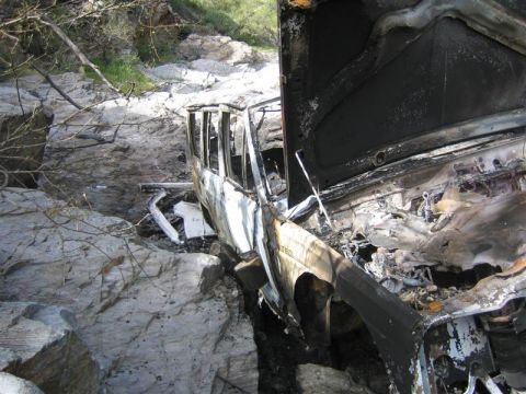 1987 Suzuki Samurai - This 1987 Suzuki Samurai appears to have been in a fire and is now situated in a rocky area.