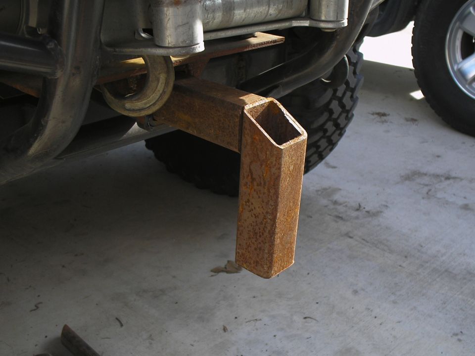 rusted tow hitch receiver extension attached to vehicle frame