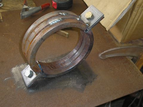 1999 Ford F-800 - A custom welded metal clamp assembly, likely for a driveshaft or exhaust.