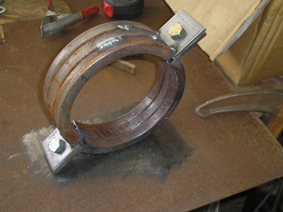 Welded metal clamp with two bolts and mounting plates