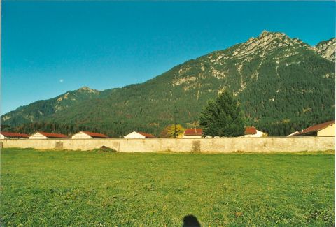 2003 Jeep TJ - A scenic view of a mountain range with a village at its base, under a clear blue sky.