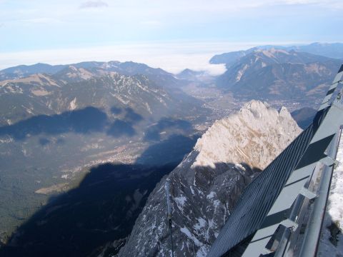 2003 Jeep TJ - A vast mountain landscape unfolds under a clear sky, with clouds obscuring the valley below.