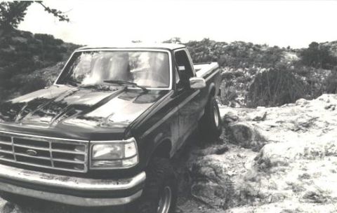 1992 Ford F-150 - This Ford F-150 is parked on a rocky, off-road path with vegetation in the background.