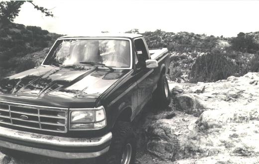 Black 1992 Ford F-150 parked on rocky terrain