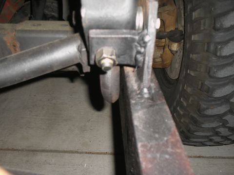 1990 Ford Bronco - Close-up view of a tow bar mounting bracket on a vehicle frame, with a tire in the background.