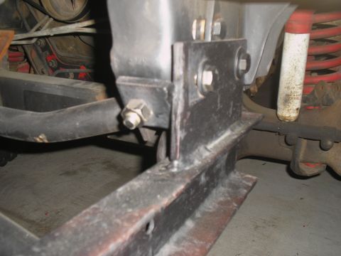 1990 Ford Bronco - Custom tow bar bracket welded to frame, with visible bolts and shock absorber.