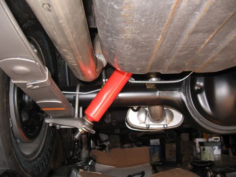 1968 Shelby GT500 - Underside view of rear suspension components, including leaf springs and red shock absorbers.