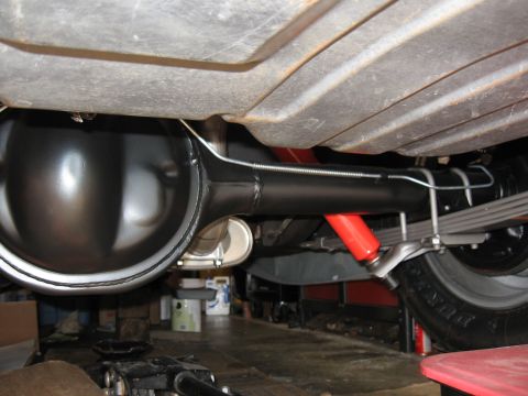 1968 Shelby GT500 - Close-up of rear axle, leaf springs, and shock absorbers, likely from a classic car.