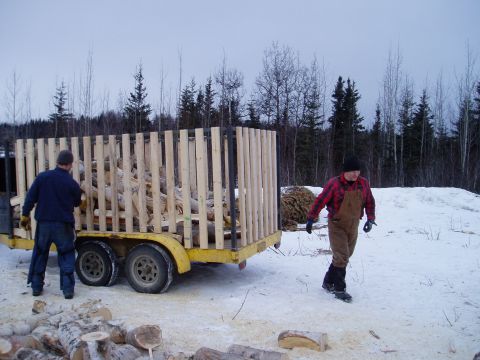 2000 Ford E350 - Men load firewood onto a trailer in a winter scene.