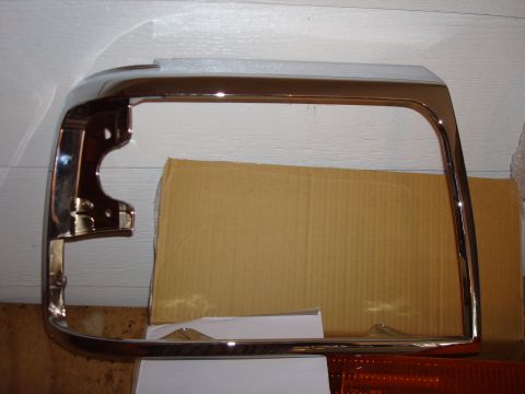 1992 Ford Bronco - A shiny chrome headlight bezel is shown, likely a replacement part for a vehicle.