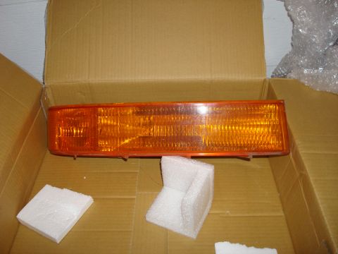 1992 Ford Bronco - Orange marker light assembly, likely for a vehicle, is shown in its shipping box with protective foam.