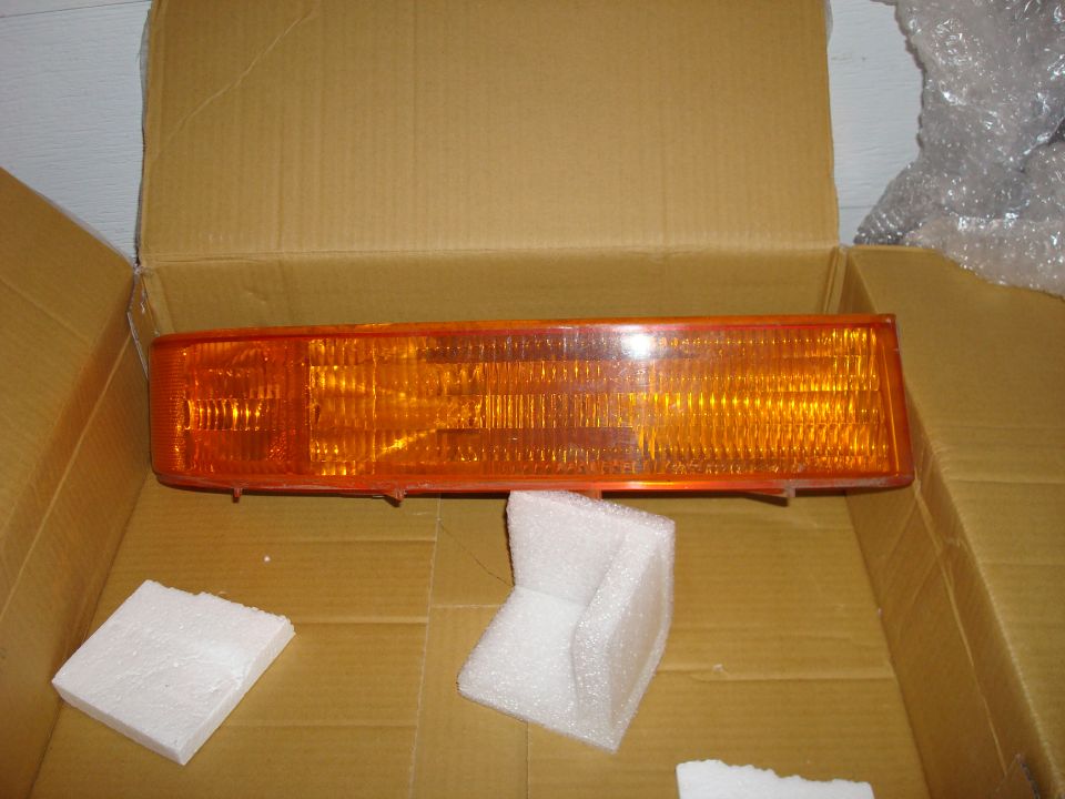 Orange marker light assembly in cardboard box