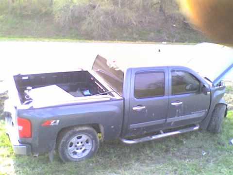 1990 Ford Bronco - A dark gray crew cab pickup truck is parked on grass with its hood open, showing Z71 badging on the fender.