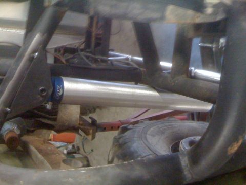1966 Ford Bronco - Close-up view of a FOX shock absorber and suspension components, with a tire visible.