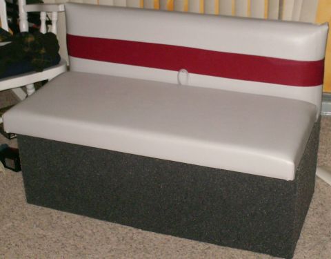 boat seat with gray cushion and white backrest with red stripe