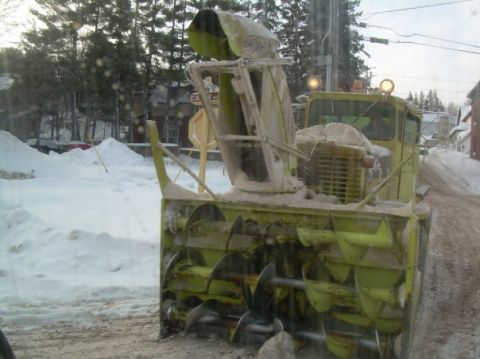 2000 Chevrolet Tahoe - A snow blower attached to a truck is seen on a snow-covered road during winter.