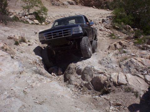 1992 Ford F-150 - This 1992 Ford F-150 is shown tackling a challenging off-road path with large rocks.