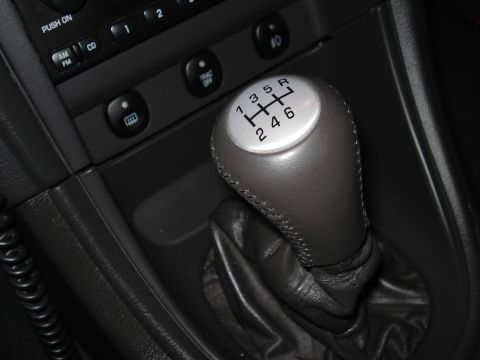 1998 Ford Taurus - Close-up of a manual transmission gear shifter inside a vehicle.