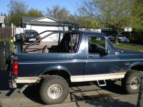 1993 Ford Bronco - This 1993 Ford Bronco features a custom roll bar and a spare tire mounted on the rear.