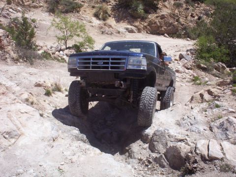 1992 Ford F-150 - A 1992 Ford F-150 navigates a challenging rocky terrain on an off-road trail.