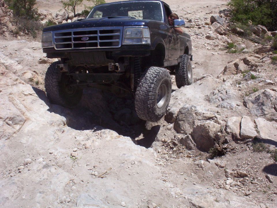 1992 Ford F-150 driving on rocky terrain, front 3/4 view
